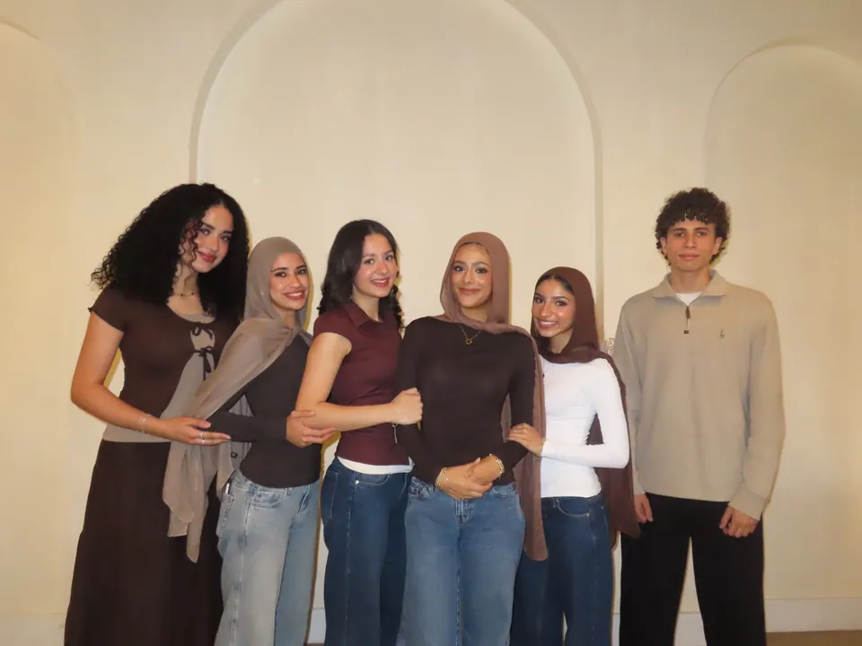 The six members of the One Good Cookie 2026–2027 board standing together in front of an arched cream wall.